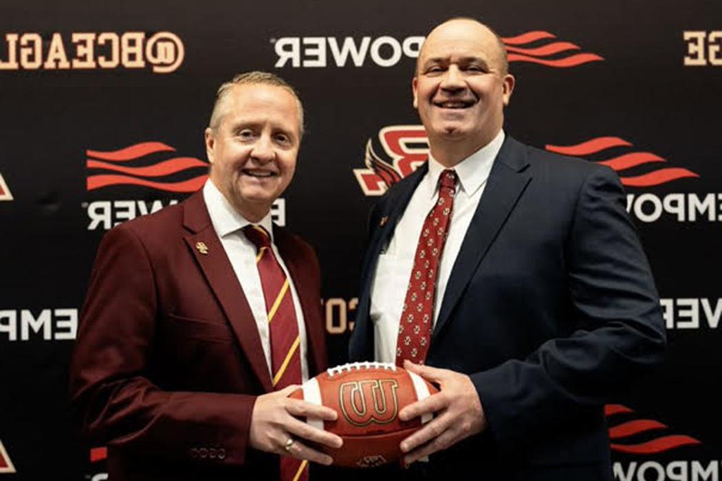 Blake James and Bill O'Brien holding a football